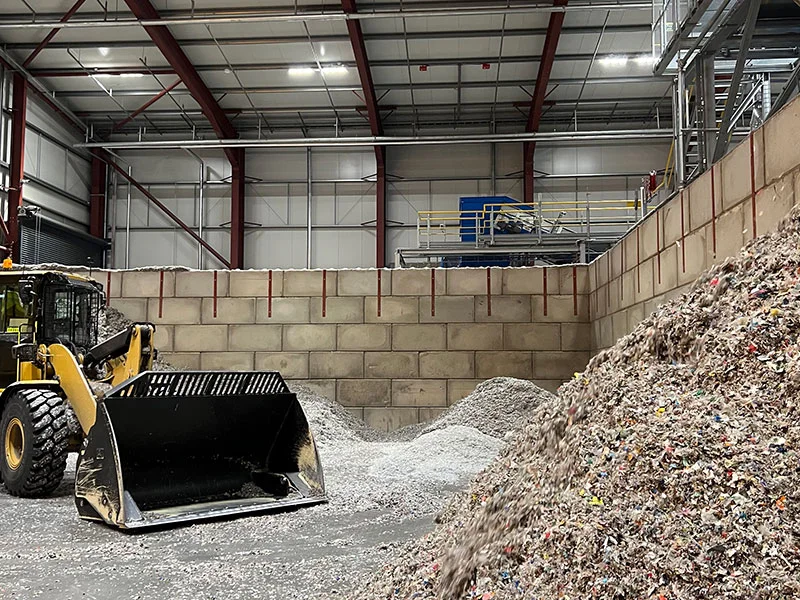 Loading shovel working material heaps inside a Legato block storage bay