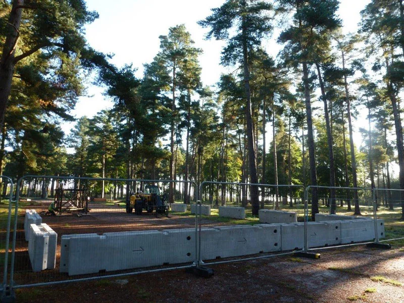 TVCB barriers lined up with mesh fencing to close off a wooded event site