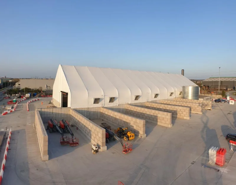 Aerial view of interlocking block storage bays beside a white fabric covered structure