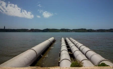 Pipelines weighted with concrete collars running out into open water