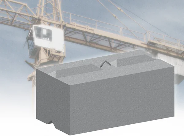 Rectangular precast counterweight block with a crane jib in the background