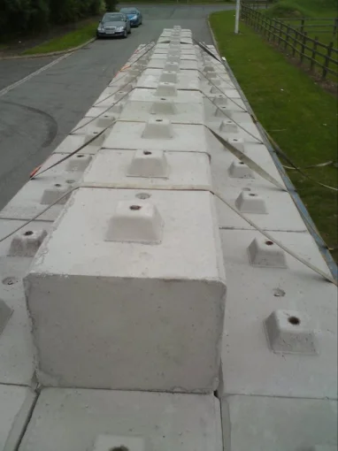 Row of Duo blocks delivered and set out along the edge of a road