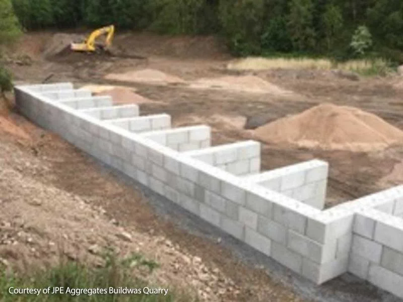 Legato interlocking blocks forming aggregate storage bays at a quarry