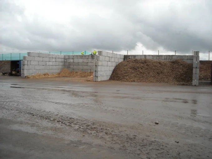 Legato interlocking block bays holding heaps of woodchip on a wet yard