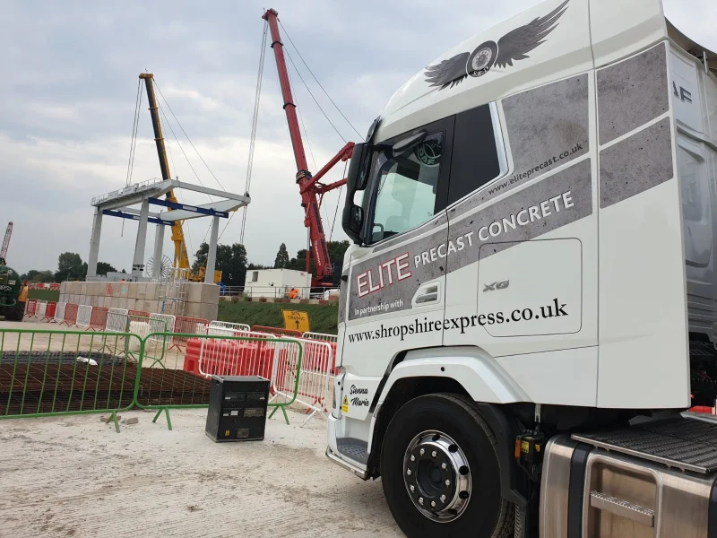 Delivery lorry on site as a crane installs Legato blocks behind