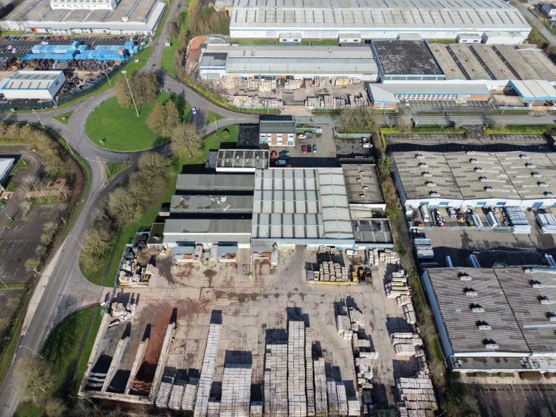 Aerial view over industrial units with concrete products laid out in the yard