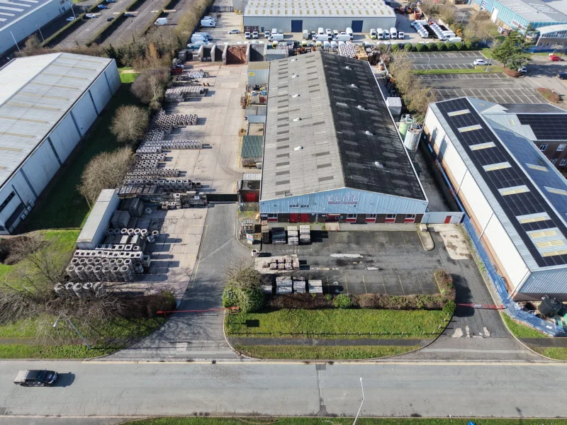Aerial view of factory units, a stock yard and stacked concrete products