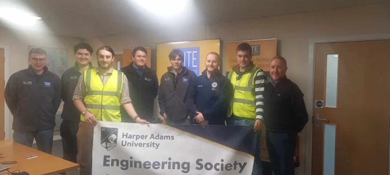 Students and staff holding a Harper Adams University Engineering Society banner